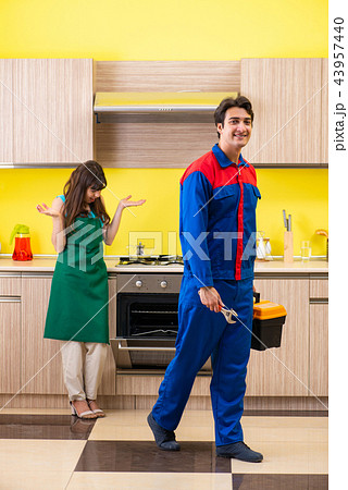 Woman with contractor at kitchen discussing repair Woman with contractor at kitchen discussing repair 43957440