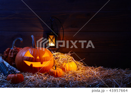 Halloween pumpkin jack lantern in dark barn, holiday concept Halloween pumpkin jack lantern in dark barn, holiday concept 43957664