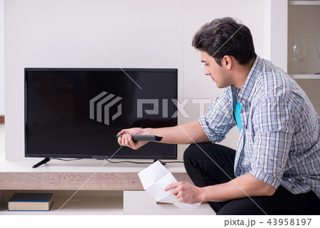 Man trying to fix broken tv Man trying to fix broken tv 43958197