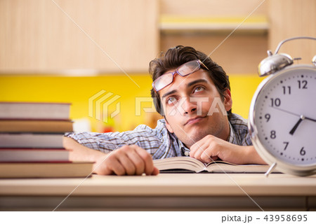Student preparing for exam sitting at the kitchen Student preparing for exam sitting at the kitchen 43958695