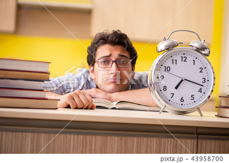 Student preparing for exam sitting at the kitchen  43958700