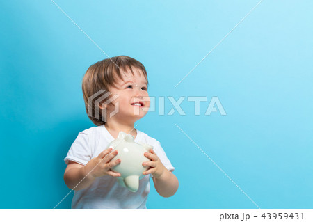 Toddler boy with a piggy bank Toddler boy with a piggy bank 43959431