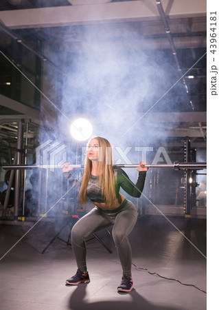 sport, fitness, training and happiness concept - sporty woman with barbell in gym sport, fitness, training and happiness concept - sporty woman with barbell in gym 43964181
