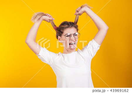 Young girl in glasses shows tongue 43969162