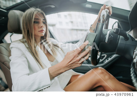 Orderly lady sending message in phone indoor Orderly lady sending message in phone indoor 43970961