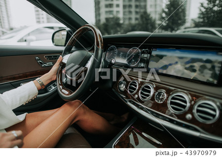 Female arm driving contemporary vehicle with dashboard Female arm driving contemporary vehicle with dashboard 43970979
