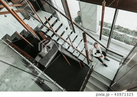 Cheerful unshaven male employer having leisure indoor Cheerful unshaven male employer having leisure indoor 43971325