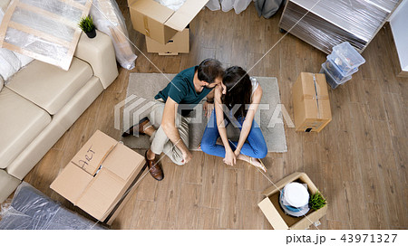 Young couple Moving in new home and unpacking carboard boxes. Young couple Moving in new home and unpacking carboard boxes. 43971327