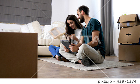 Beautiful young couple just moved in new flat Beautiful young couple just moved in new flat 43971374