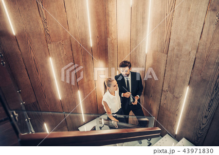 Cheerful lady speaking with satisfied man inside 43971830