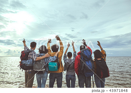 Group of people jumping with their hands up Group of people jumping with their hands up 43971848