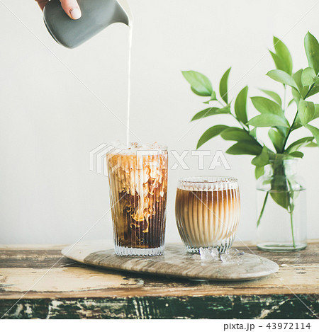 Iced coffee in tall glass with cream, square crop Iced coffee in tall glass with cream, square crop 43972114