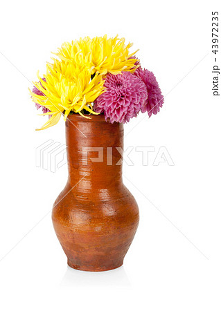 Big clay jug with flowers isolated on white Big clay jug with flowers isolated on white 43972235