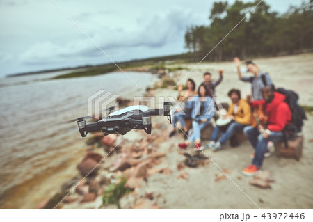 Tourists using the quadcopter in their vacation Tourists using the quadcopter in their vacation 43972446