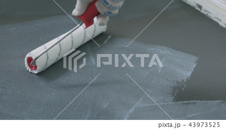 closeup applying protective coating on the concrete floor closeup applying protective coating on the concrete floor 43973525
