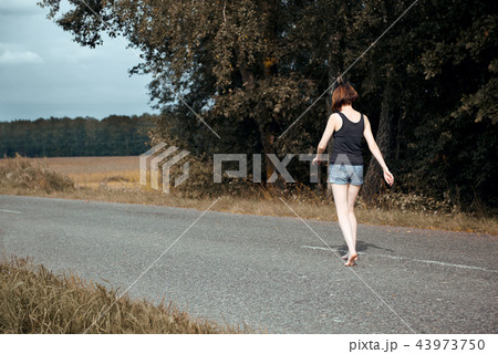 young girl posing on the country road and field young girl posing on the country road and field 43973750