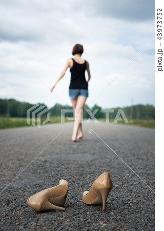 young girl posing on the country road and field 43973752