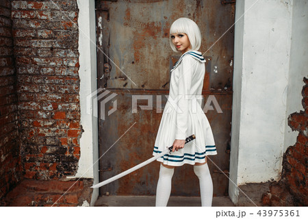 Anime girl with sword poses on abandoned factory Anime girl with sword poses on abandoned factory 43975361