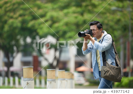 Photographer working in park 43977142