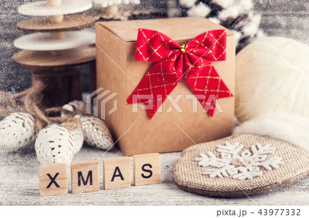 Craft gift box, red bow, wooden christmas trees 43977332