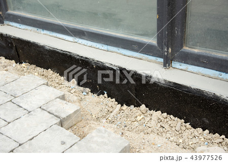 Waterproofing house foundation with spray on tar Waterproofing house foundation with spray on tar 43977526