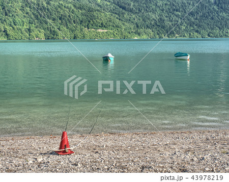 The incredibly magic green lake with fishing boats The incredibly magic green lake with fishing boats 43978219