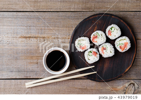 Japanese sushi rolls on wooden plate, flat lay 43979019