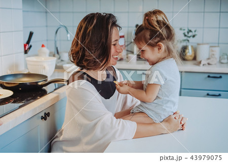 Mom and little daughter having fun together Mom and little daughter having fun together 43979075