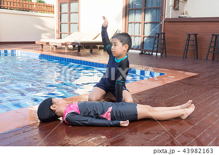 Boy helping drowning child girl doing CPR. Boy helping drowning child girl doing CPR. 43982163