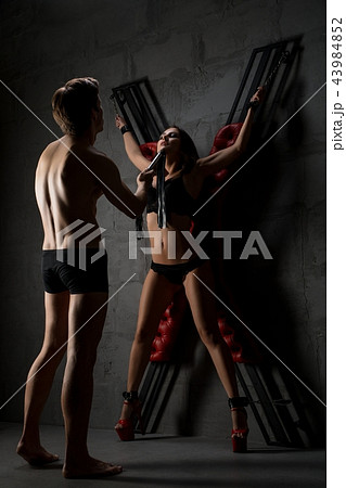 Sexy lovers perfoming erotic bdsm play shot 43984852