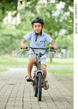 Boy riding bicycle 43986901