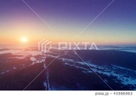 Sunset over countryside in winter. Aerial view Sunset over countryside in winter. Aerial view 43986963