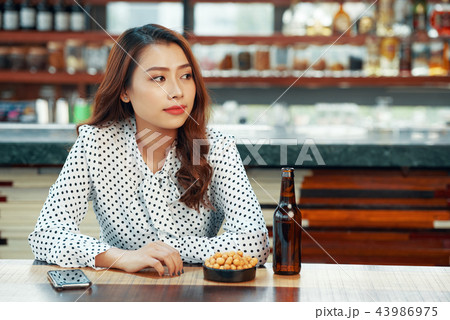 Pretty woman waiting in bar 43986975