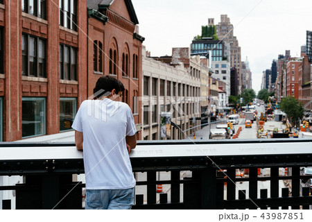 Young man looking at New York cityscape 43987851