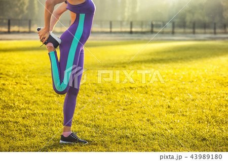 Woman athlete at the morning warm-up at the stadium. Woman athlete at the morning warm-up at the stadium. 43989180