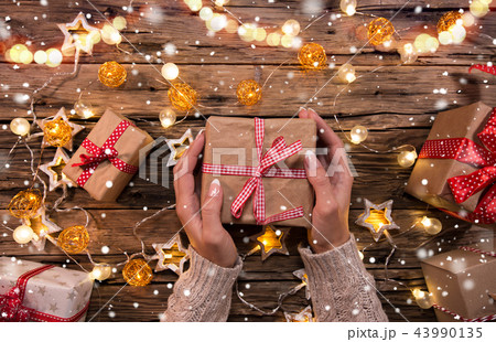 Top view of woman hands with gift box. Top view of woman hands with gift box. 43990135