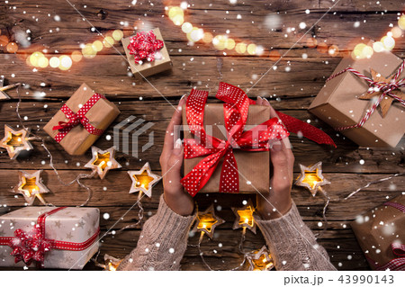 Top view of woman hands with gift box. Top view of woman hands with gift box. 43990143