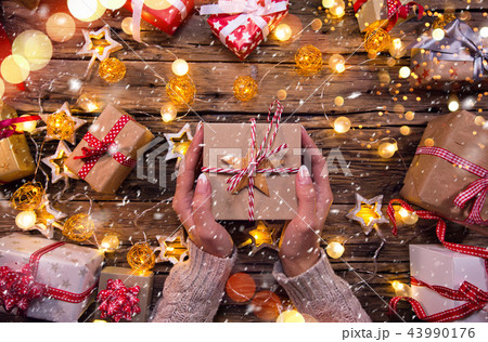 Top view of woman hands with gift box. Top view of woman hands with gift box. 43990176