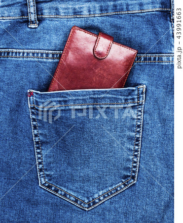 brown leather purse lies in the back pocket 43991663