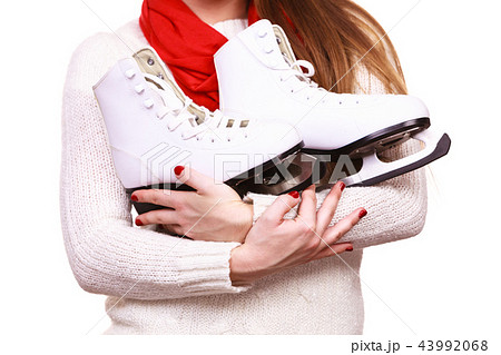 Close up woman holds ice skates. 43992068