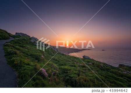Walking path along the Cornish coast at sunset 43994642