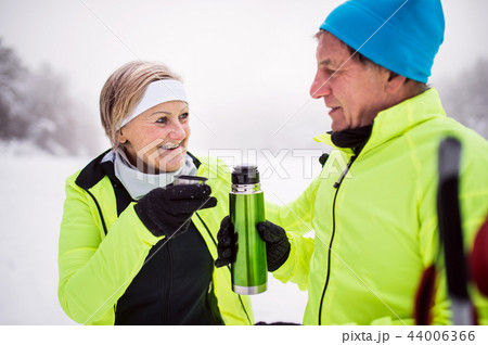 A senior couple cross-country skiing in winter. 44006366