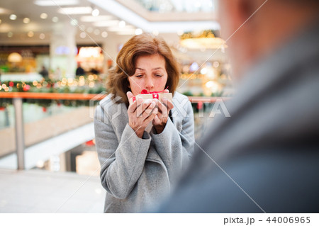 Senior couple with present doing Christmas shopping. 44006965