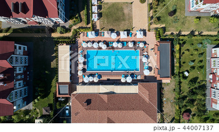 Aerial view on people in swimming pool. Top view of people sunbathing pool. 44007137