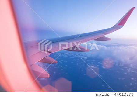 SuBeautiful sunset with cloudy sky from the airplane window. SuBeautiful sunset with cloudy sky from the airplane window. 44013279