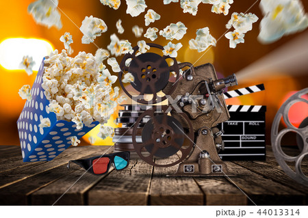 Pop-corn, movie tickets, clapperboard and other things in motion. 44013314