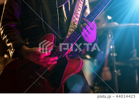 A rocker is playing guitar on stage. A rocker is playing guitar on stage. 44014425