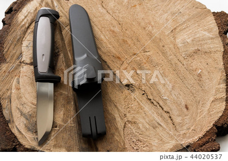 Knife on a wooden background with a plastic cover. 44020537