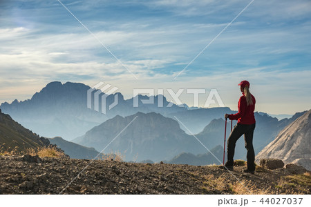 Sporty Young woman on mountain trail Dolomites Mountains, Italy 44027037