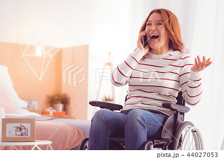 Joyful incapacitated woman talking on phone 44027053